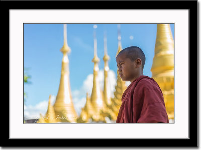 A novice monk in front of a temple