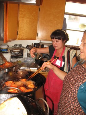 Claudine and Kasma frying cuttlefish cakes