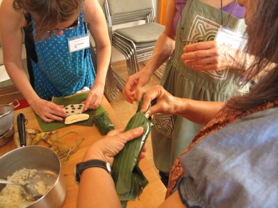 Banana leaf, sticky rice, banana, black beans, tucking in the ends