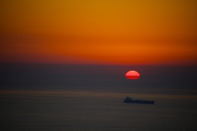 Red Sun Setting On Ship 