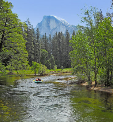 River rafter along the Merced with Half Dome in the background 
