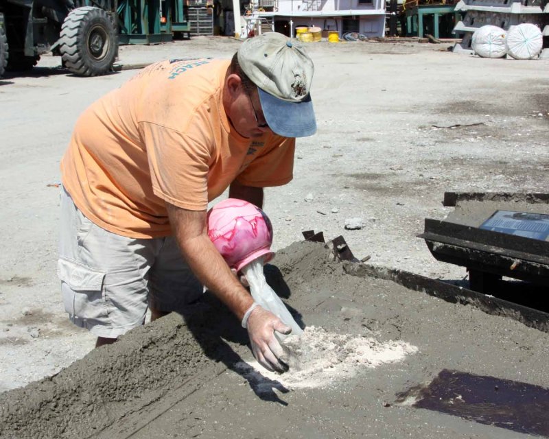 Mixing ashed into wet concrete