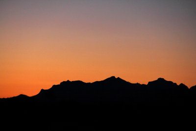 Break of dawn silouetting the distance ridge
