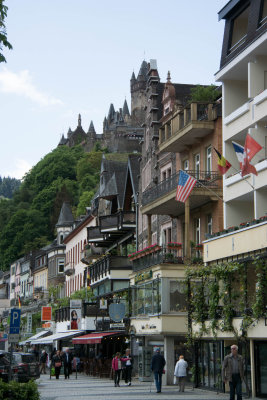City buildings with castle above.