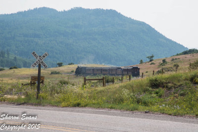 Train 215 heads west away from the crossing