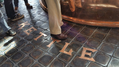 Notice how the tiles are cut to fit the copper letters