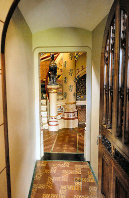 CC031. A corridor leading to an ornate staircase. 