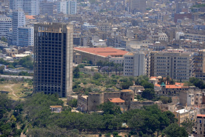 Unfinished concrete shell rising next to the Beys Palace, Oran