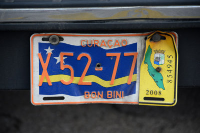 An older Curaçao license plate with a large flag
