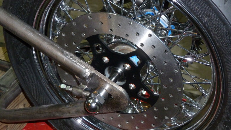 Rotor moved out far enough to be even with the rim edge. Close enough to bridge the gap for the caliper brace.
