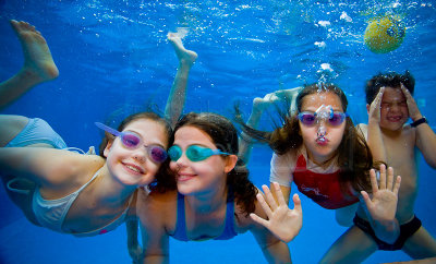 Four children swimming underwater