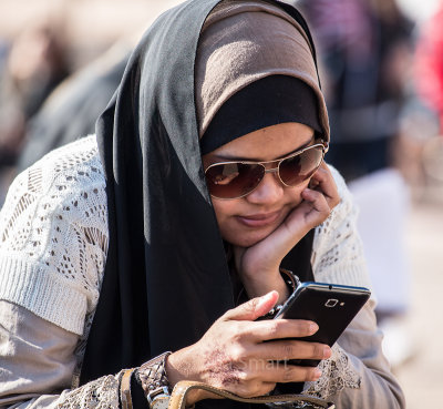 Girl in hijab with iPhone