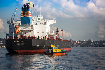 Unique Fidelity container ship with pilot boat on Sydney Harbour