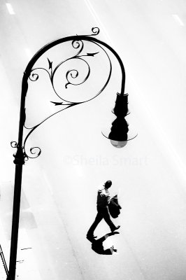 Lamp in the Rocks and man crossing street in mono