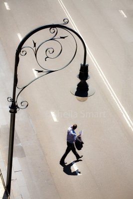 Lamp in Rocks and man crossing street