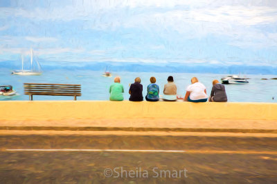 Visitors sitting on wall at Kaiteriteri web.jpg