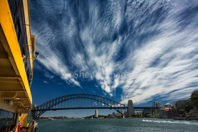 Sydney Harbour Bridge from ferry with magic cirrus clouds 