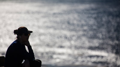 Young woman looking out to sea 