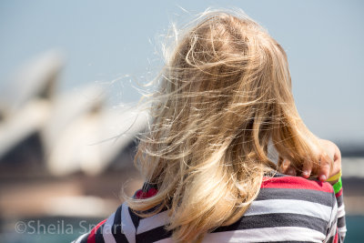 Little blonde girl on ferry with Sydney Opera House backdrop