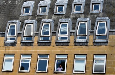 Man in window Edinburgh Scotland UK 