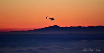 R44 above fog at sunset Seattle 