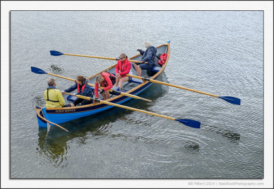 Four Women Rowing one Man in a Boat