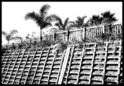 Wall of concrete and stones and weeds