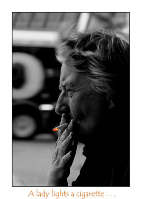 A lady lights a cigarette