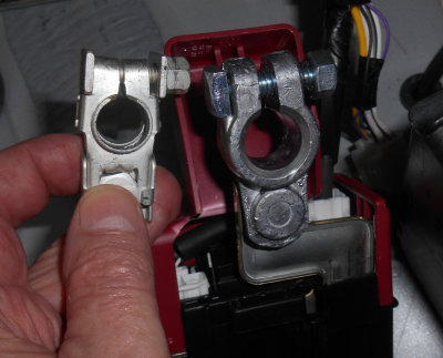  OEM battery terminal on left, LYNX Marine terminal installed on right.