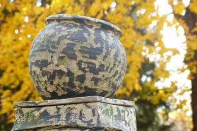 Atop a ceramic pedestal sits this crock