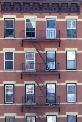 Another rear view of an older building's fire escapes and great dental molding.