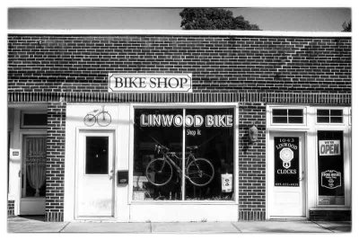 A village bike shop in Linwood, NJ, right along a busy highway with the sidewalk next to the road! 