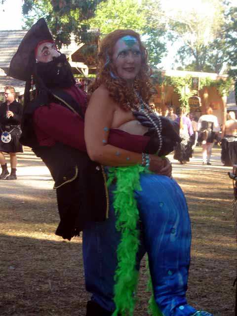 What is he doin to that mermaid?