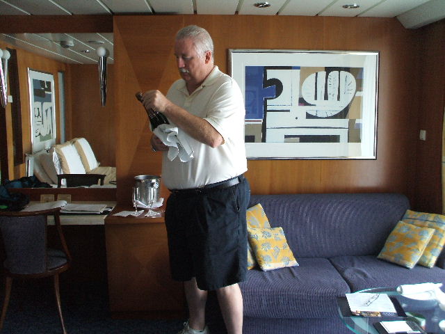 On Celebrity our cabin -hubby opening our champagne