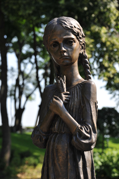 Sculpture of a girl clutching a handful of wheat - Bitter Memory of Childhood