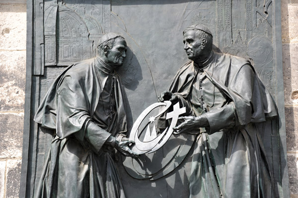 Pope John Paul II passing the church on to Pope Benedict XVI