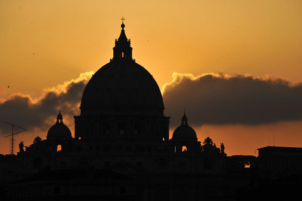 Silhouette of the dome of St. Peter's with an orange sky