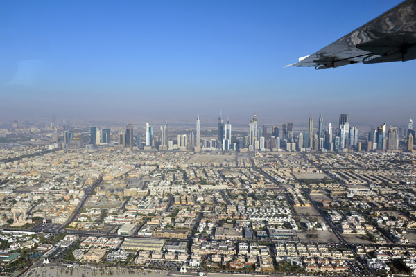 Flying along Jumeirah Beach with the towers of Sheikh Zayed Road