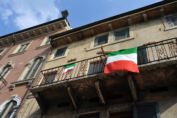 Italian flags hanging from a balcony, Verona