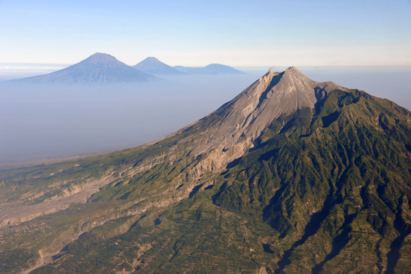 Looking west past Mt. Merapi to the central Java volcanoes of Sumbing, Sundoro and the Dieng Plateau
