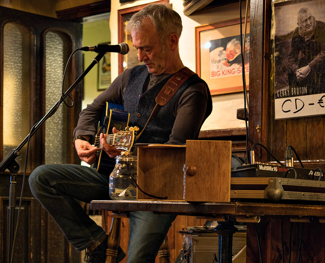 Gerry Bruton strumming and singing