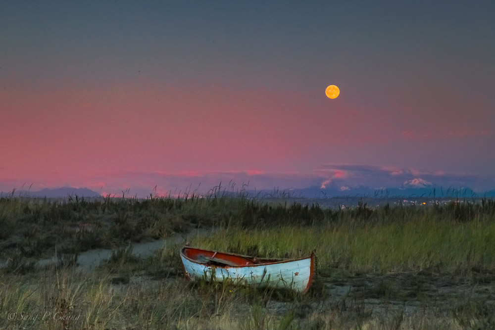 a deserted boat with full moon