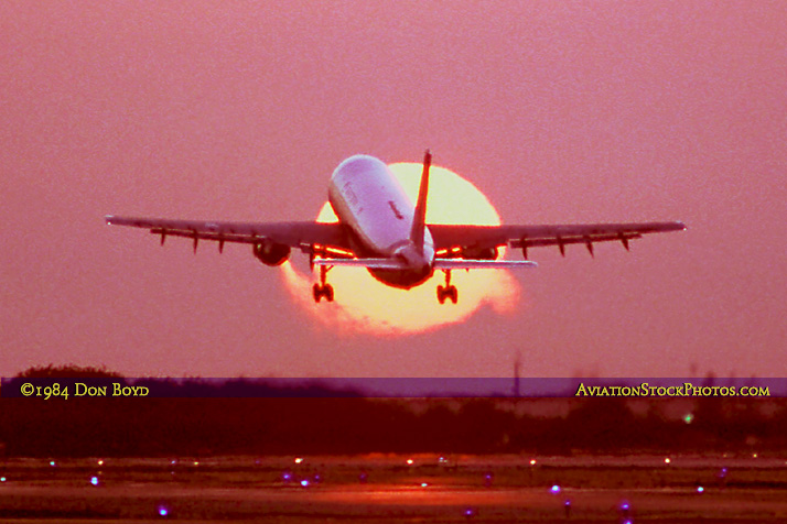 1984 - Eastern Airlines Airbus A-300 taking off in front of the setting sun at Miami International Airport