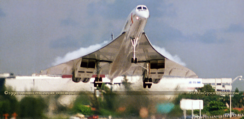 1990 - British Airways Concorde G-BOAA with condensation on top of the delta wing landing on runway 30 at MIA