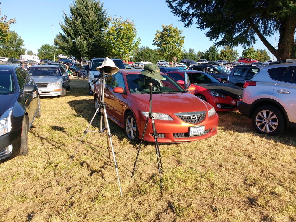 My car, and hat-covered cameras getting ready for the big event.  Youll notice, a lot more cars have arrived :)