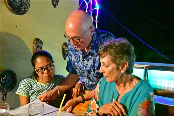 CUBA_3551 Myo, Ben, Susan checking the menu at Casa Prado