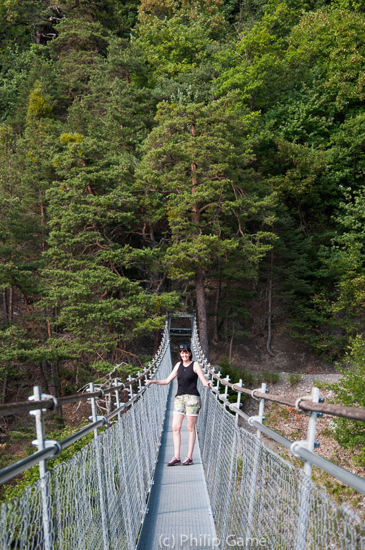 Our hostess Nelly pauses on a suspension bridge 