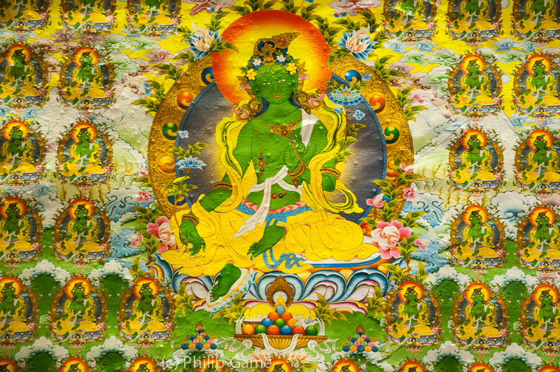 Tibetan Buddhist murals cover the interior walls of the modern stupa