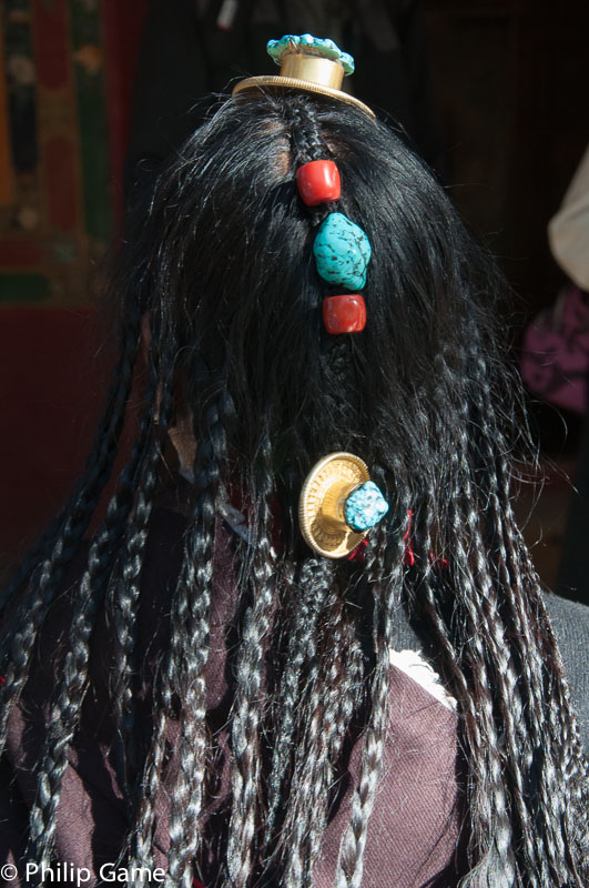 A woman visiting the Norbulingka shows off her hair