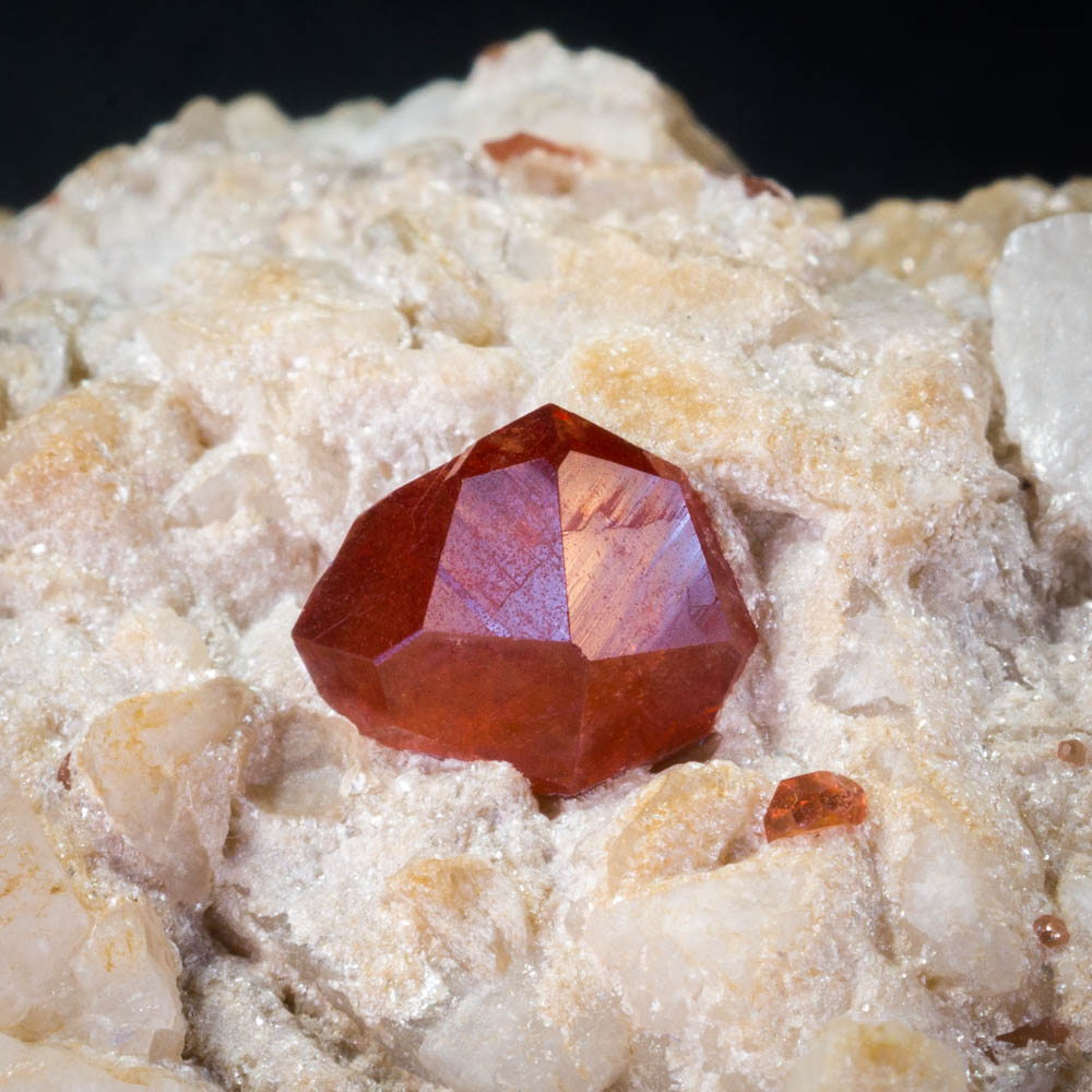 Spessartine garnet. Gilgit, Pakistan. gemmy 7 mm crystal on 5 x 4 cm feldspar matrix